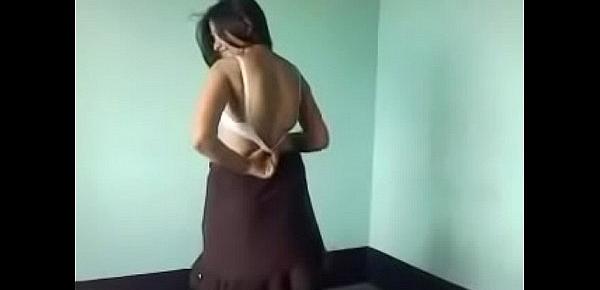  Removing her dress in bedroom